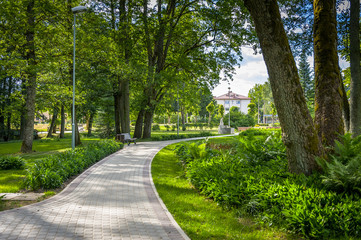 Baldone city park with sulfur water fountain and curved walk path in the sunny day. Baldone, Latvia.