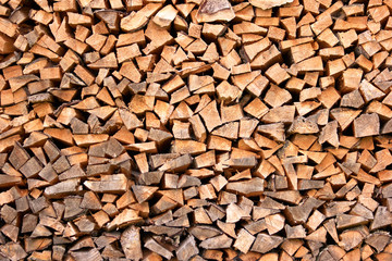 Stacked firewood close up. Nicely stacked pile of firewood close up. Natural wall of chopped dry firewood. Preparation of firewood for winter.
