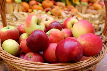 Red apples in the wooden basket at the market. Fruit and business concept.