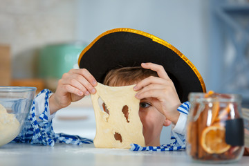 Photo session - friendly family. The family cooks together. Son kneads dough with flour.