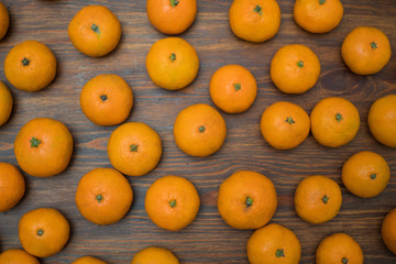 Juicy bright orange tangerines on a wooden background. Fruit set. Background
