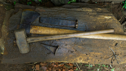 Hammer, ax and slitter on board at the farm