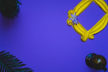 Purple background yellow frame notebook pen coffee mug globe flower flat lay instant photography camera keyboard computer 