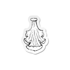 retro distressed sticker of a traditional hand drawn floral swirl