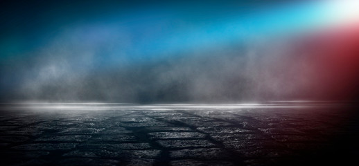 Fototapeta premium Wet asphalt, reflection of neon lights, a searchlight, smoke. Abstract light in a dark empty street with smoke, smog. Dark background scene of empty street, night view, night city.