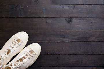 canvas shoes on black wooden floor