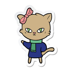 sticker of a cute cartoon cat in winter clothes