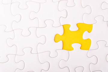 White jigsaw puzzle and missing pieces with selective focus and crop fragment