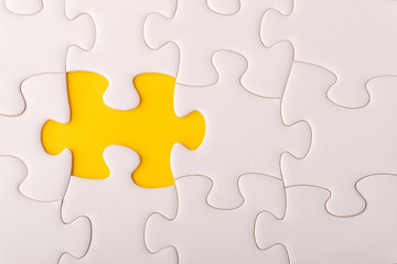 White jigsaw puzzle and missing pieces with selective focus and crop fragment