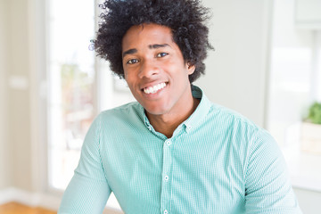 African American business man wearing elegant shirt with a happy and cool smile on face. Lucky person.