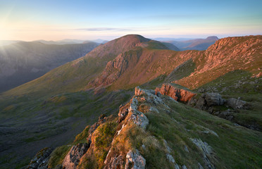 Sunset over Ennerdale from Scoat Fell with views of Pillar In the English Lake District, UK.