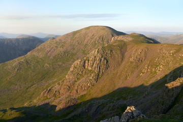 Sunset over Ennerdale from Scoat Fell with views of Pillar In the English Lake District, UK.