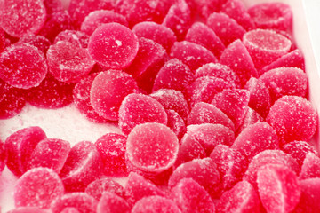 Many gelatin sweet red strawberries fruit candy candies sugar. Assorted color jelly sweets. Pile of...