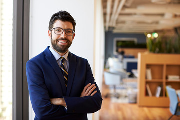 Fototapeta premium Portrait Of Businessman In Modern Office Standing By Window