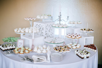 Delicious white wedding reception candy bar 