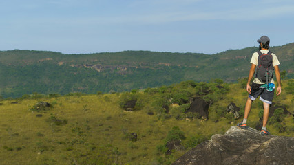Man exploring nature with backpack and camera