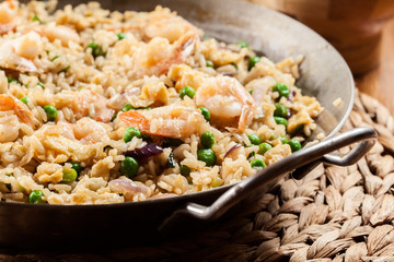 Fried rice with shrimp and vegetables on a frying pan