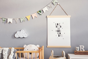 Stylish and cute scandinavian decor of  newborn baby room with mock up poster, natural toys,...