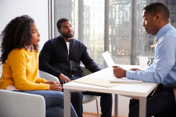 Couple Meeting With Male Financial Advisor Relationship Counsellor In Office