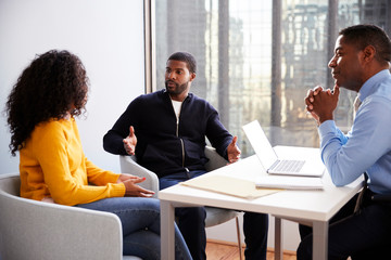 Couple Meeting With Male Financial Advisor Relationship Counsellor In Office