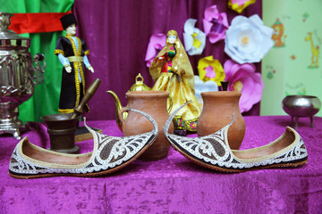Fototapeta premium Piti food bowl . The main ingredients of Azerbaijani Piti bowls. Arabian Embroidered Leather Shoes . Traditional Arabic shoes . Arabian oriental shoes in the Aladdin style .
