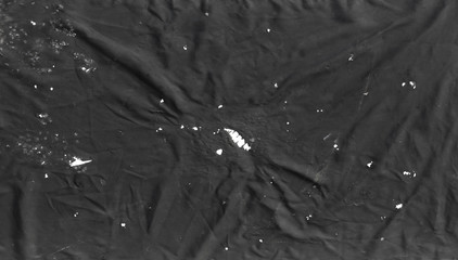 Fototapeta premium black abstract background of old torn fabric