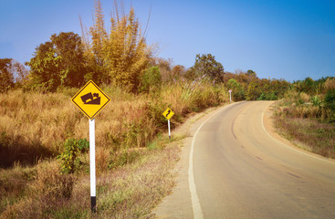 Warning road sign uphill and road curve - Steep grade hill traffic sign