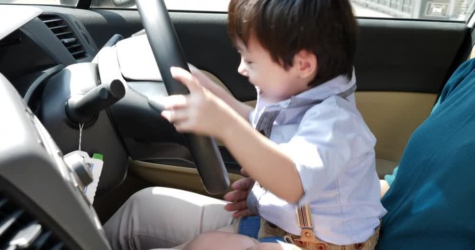 child little boy on car play driving.