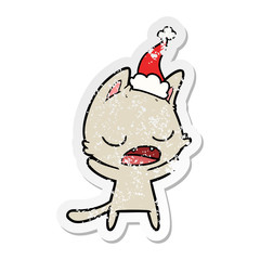 talking cat distressed sticker cartoon of a wearing santa hat