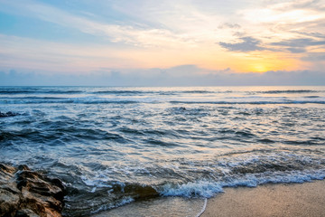 Travel And vacation concept background, beautiful tropical beach sunrise sea view. soft wave hitting sandy beach