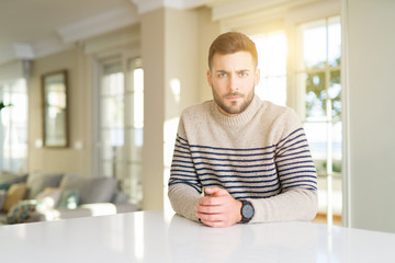 Young handsome man at home skeptic and nervous, frowning upset because of problem. Negative person.