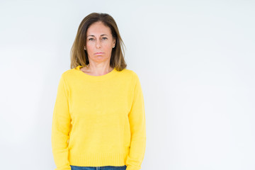 Beautiful middle age woman wearing yellow sweater over isolated background depressed and worry for distress, crying angry and afraid. Sad expression.