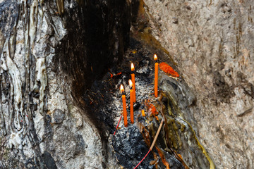 burning candles on the stone and melted candle wax