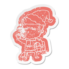 cartoon distressed sticker of a man sweating wearing santa hat