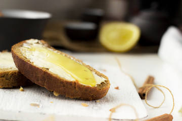 Pieces of bread with butter and honey, macro