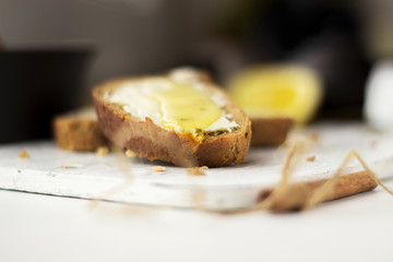 Pieces of bread with butter and honey, macro