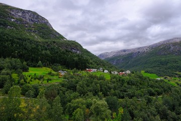Fototapeta na wymiar Beautiful view on Naeroydalen Valley and Peaks On Stalheim, Voss Norway. Little village with colorful houses.