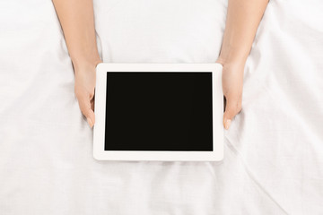 Young girl holding digital tablet with blank screen