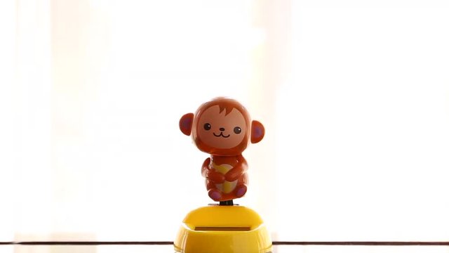monkey solar dancing doll on transparent curtain background
