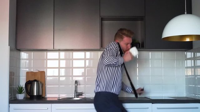 Young Ginger Man in hurry drinking coffee and picking up keys