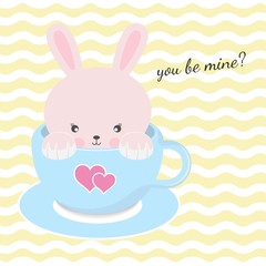 Cute rabbit sitting in cup of coffee with pink hearts.