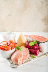 Animal protein sources - raw beef meat steak, chicken breast fillet, salmon fish, eggs, dairy milk, shrimps, cheese, copy space