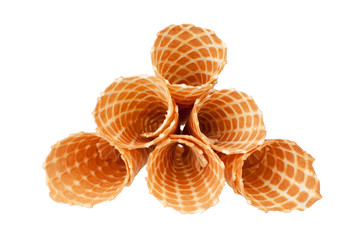 Pile of crispy ice-cream waffle cones on white background isolated closeup top view, empty...