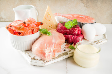 Animal protein sources - raw beef meat steak, chicken breast fillet, salmon fish, eggs, dairy milk,...