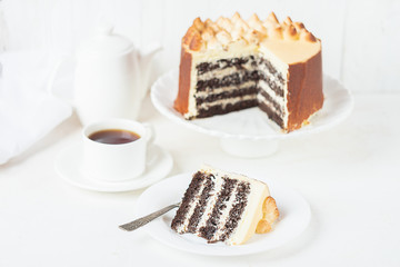 Chocolate cake with thick white cream on a white bowl on a light background. Homemade baking....