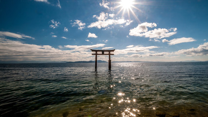 Wide-angle landscape view of the less-known "floating" torii gate of Shirahige Shrine in Lake Biwa near Shiga Prefecture's Takashima City.