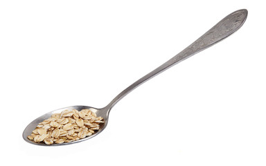 A spoon with oat-flakes cut out.