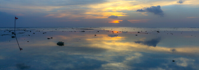Sunset with reflection in the  sea Indonesian island Gili Travanagan 