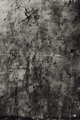 vertical background of old uneven dark gray plaster