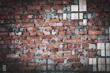 Background from old cracked bricks with shabby tiles